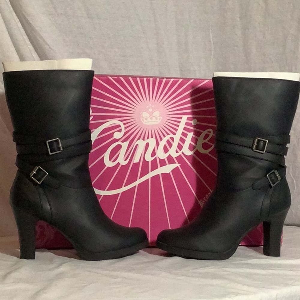 Women’s black mid length high heel boots.